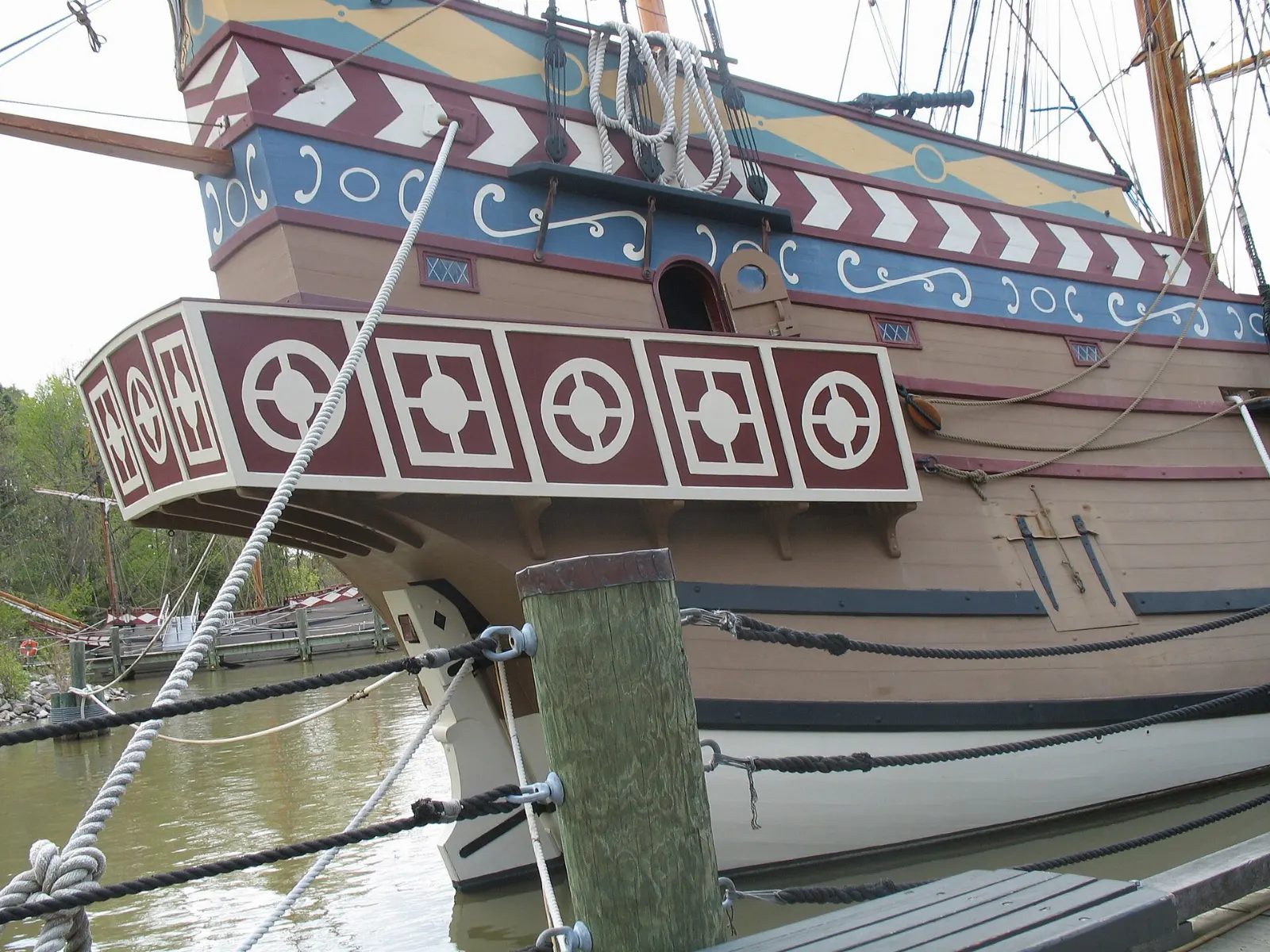Replica seventeenth-century sailing ships moored at a wooden pier on the James River, Williamsburg, Virginia