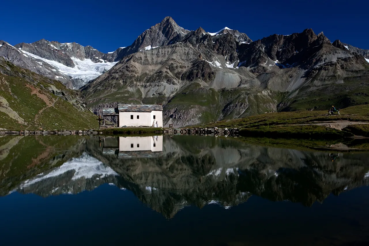 Small white chapel beside the dark lake of Schwarzsee below the Matterhorn, Zermatt, Switzerland