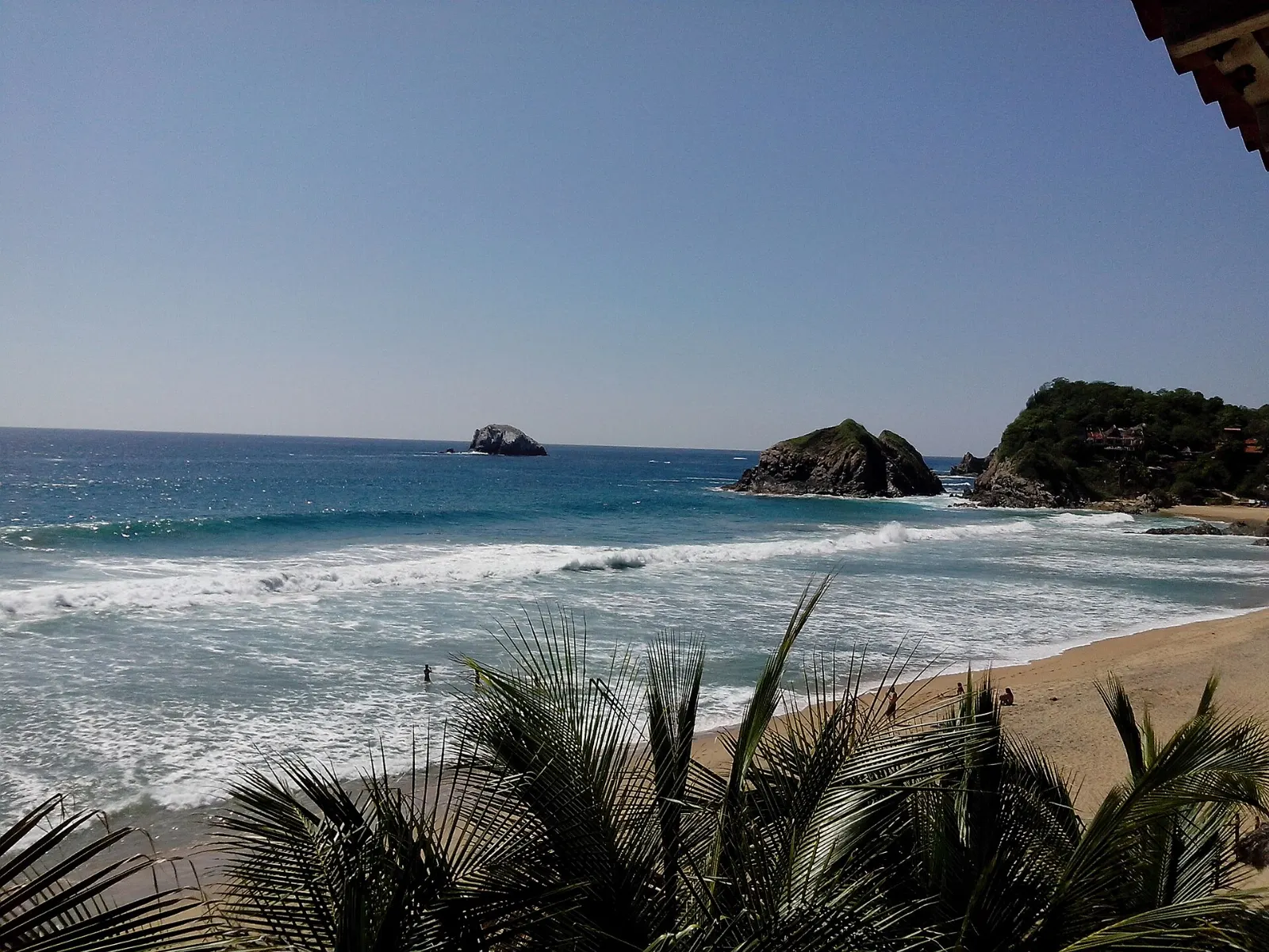 Palapa restaurants and sand along the main beach in Zipolite, Oaxaca