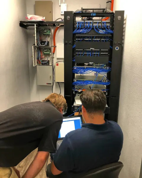 Cabling Solutions Group technicians working on a network rack in Tucson, AZ