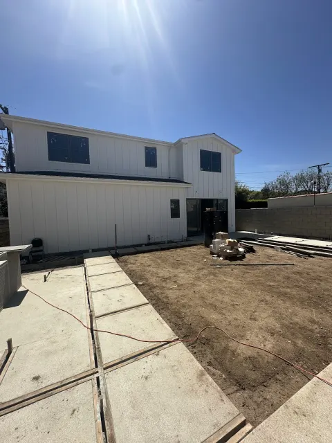 Backyard ADU construction site behind a two-story home in Los Angeles
