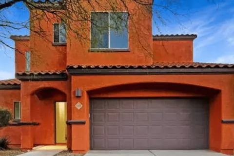 Exterior stucco painting on a two-story home in Tucson, AZ