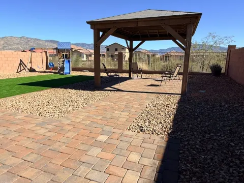 Pergola, paver patio and artificial turf backyard in Tucson, AZ