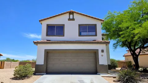 Exterior stucco painting on a two-story home in Tucson, AZ