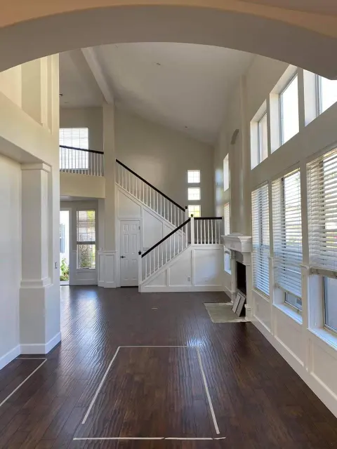 Interior painting in a Tucson home with a staircase and tall windows