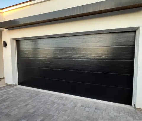 Modern black garage door installation on a Phoenix, AZ home