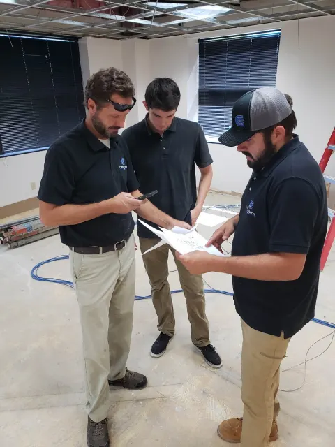Cabling Solutions Group team reviewing plans on a commercial job site in Tucson