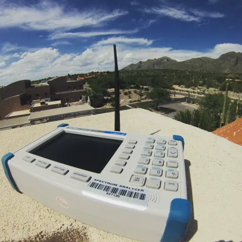 Rooftop signal testing with professional analyzer equipment in Tucson, AZ